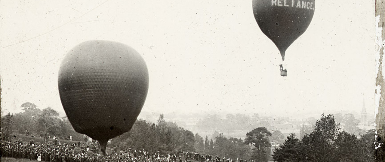 A photo from the LAMAS collection, of balloons flying over London. It is a black and white photo.