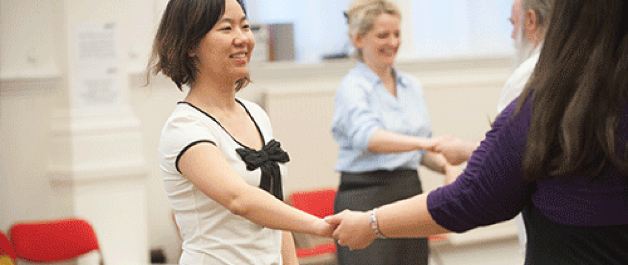 A Lindy Hop class at Bishopsgate Institute. The couples are taking each other's hands, preparing to dance.