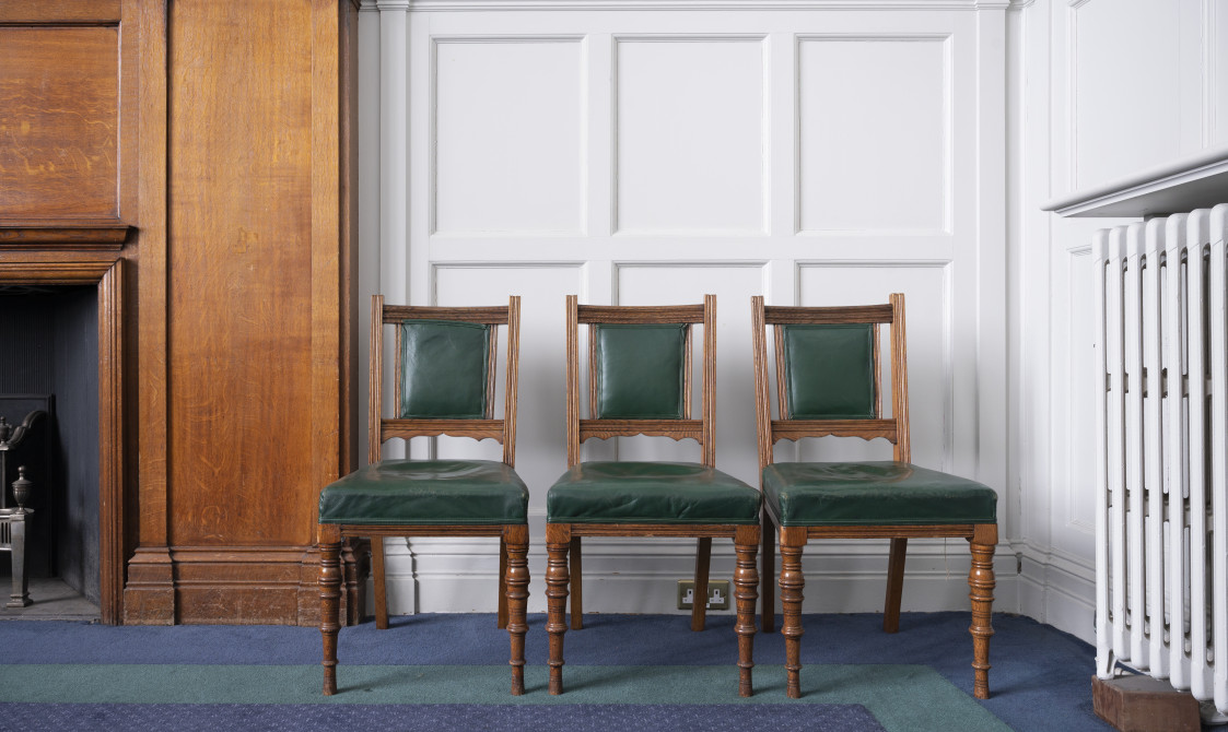 A photograph of three green chairs in the Boardroom at Bishopsgate Institute in central London.